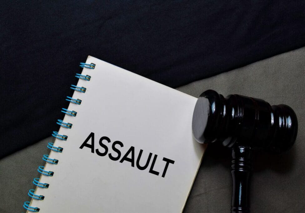 Assault text on a book and gavel isolated on office desk Assault text on a book and gavel isolated on office desk.