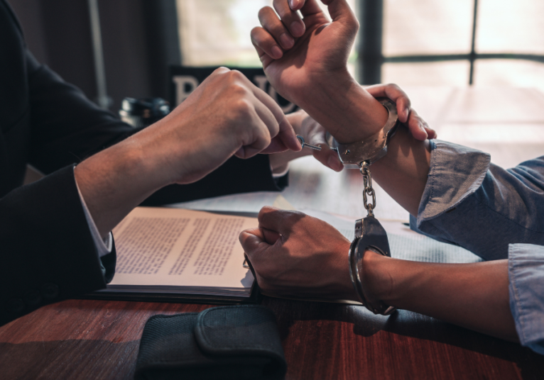 image of criminal lawyer in surrey getting client's handcuffs off and all charges dropped.